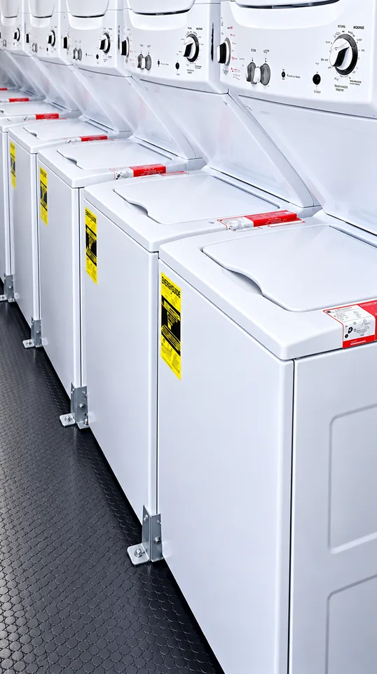 Commercial washing machines inside a 24 ft mobile laundry trailer